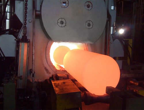 Aluminium billet entering the JANCO extrusion press